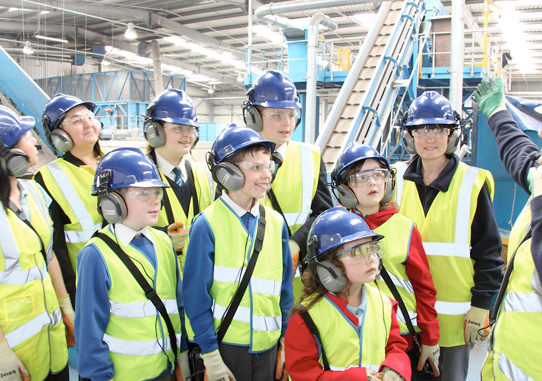 students in a recycling centre learning about recycling