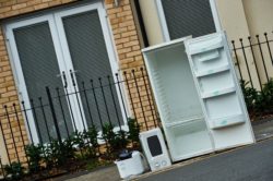 Fridge fly tipped on a pavement