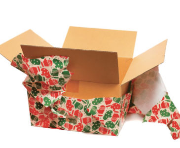 Cardboard box with torn wrapping paper