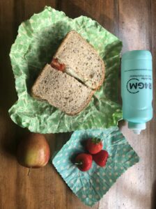 image of sandwhich, drinks bottle strawberries' and and apple