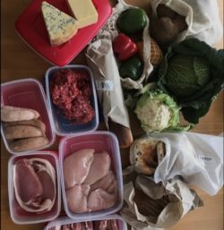meat, cheese, bread, fruit and vegetables in reusable boxes and bags