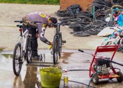 Man cleaning bike wheels