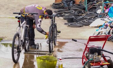 Man cleaning bike wheels