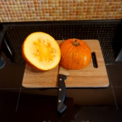 Pumpkin on a chopping board chopped in half