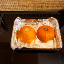 Pumpkins getting cooked in the oven