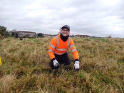 Man in high visibility jacket planting trees