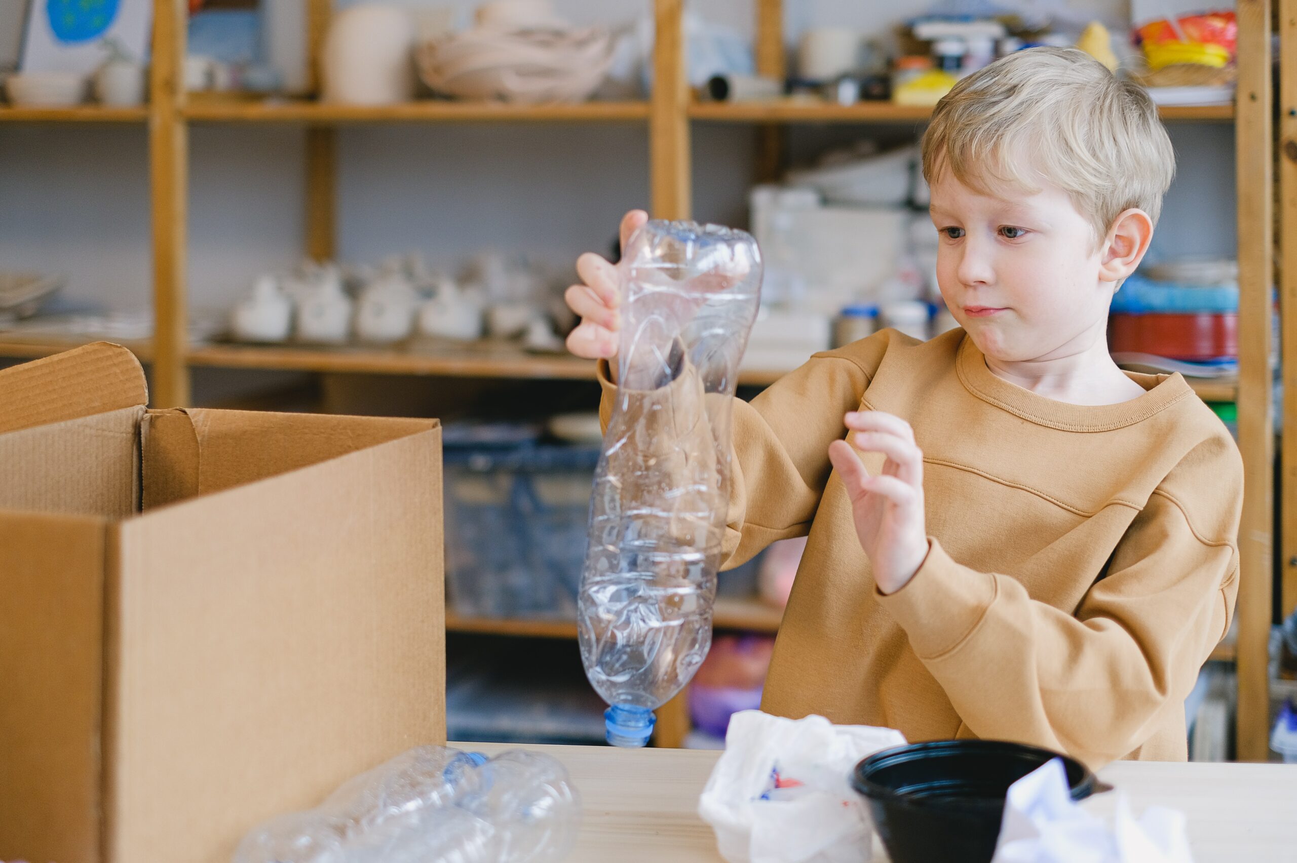 young boy with a plastic water bottle