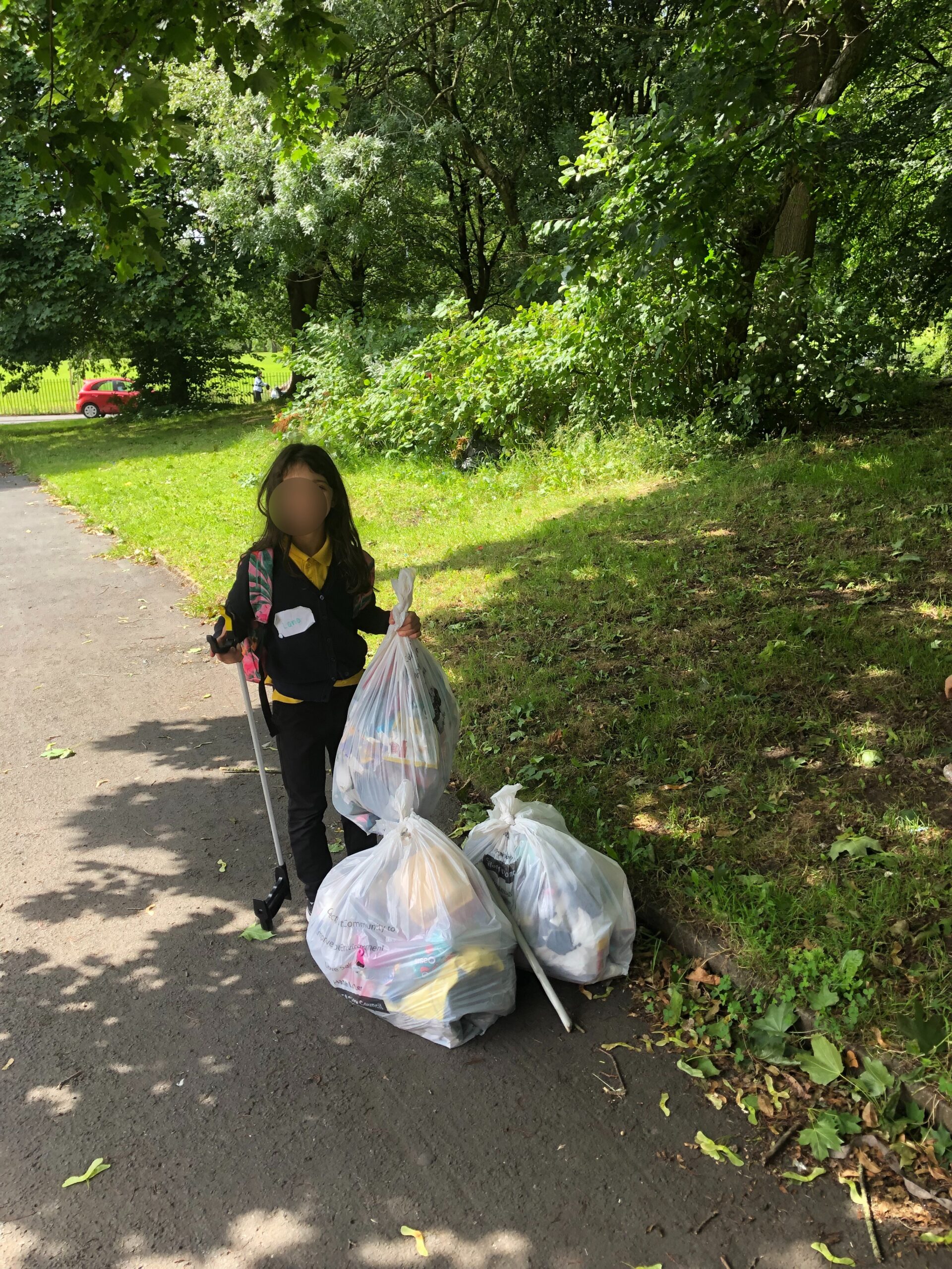 Girl litter picking in Salford