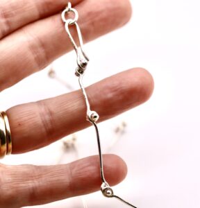 a necklace being held