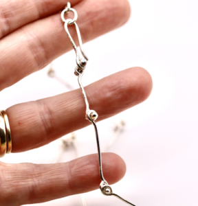 a necklace being held