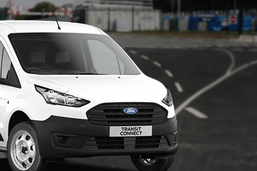 A white transit van entering a recycling centre.