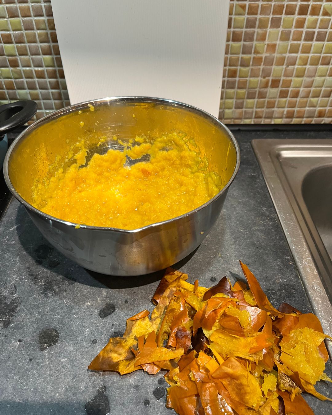 Flesh of roasted pumpkin put into metal bowl
