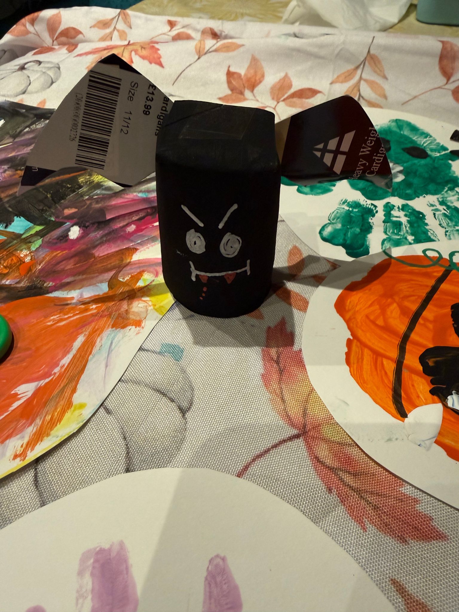 A toilet roll tube painted to look like a bat