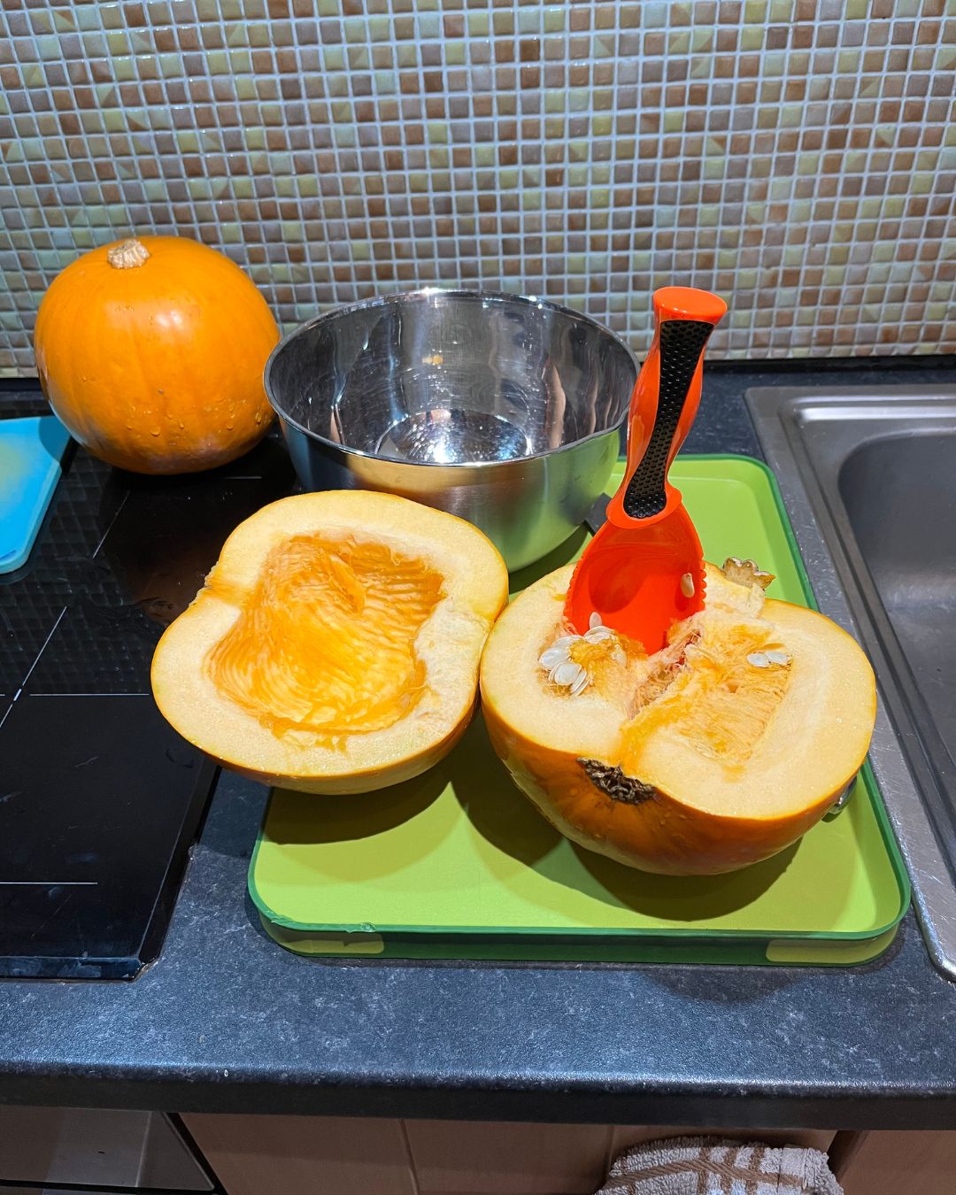 Halved pumpkin on baking tray