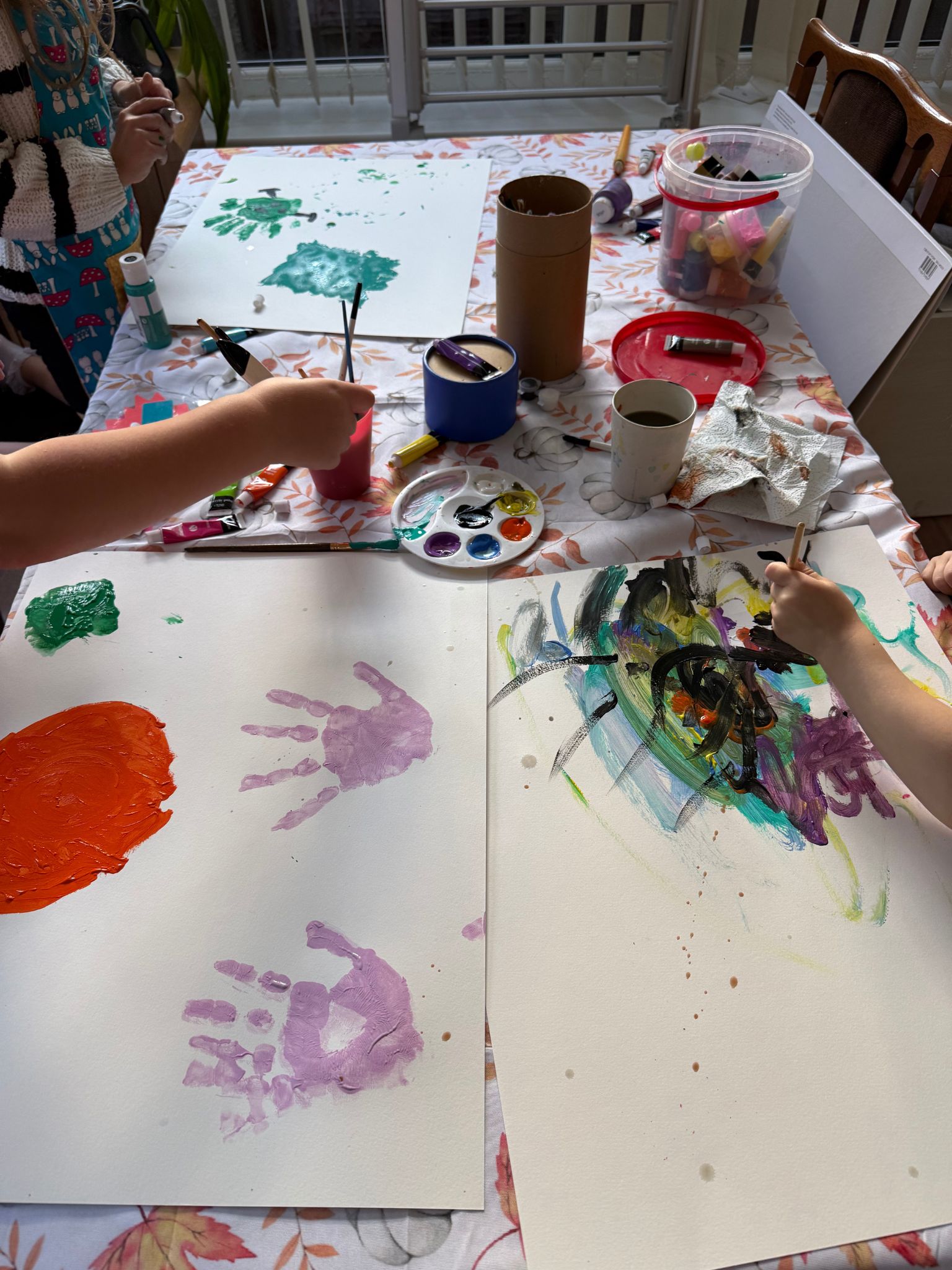 2 children paint at a table