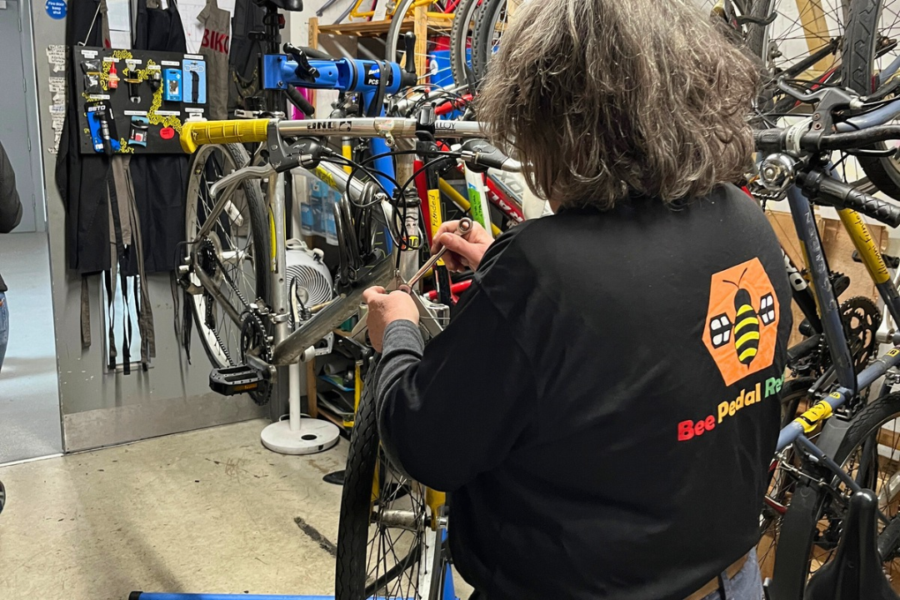 Woman repairs a bike wheel