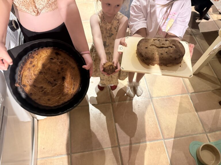 Children hold pumpkin cakes